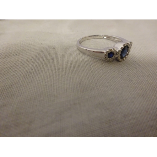 231 - 18ct white gold good quality sapphire and diamond set ring, the blue sapphires surrounded by small w... 