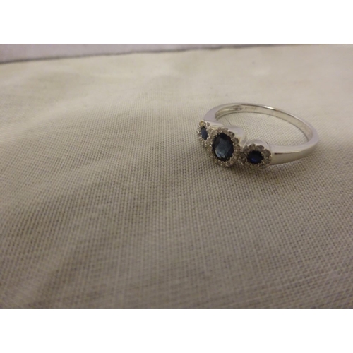 231 - 18ct white gold good quality sapphire and diamond set ring, the blue sapphires surrounded by small w... 