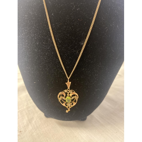 235 - A Victorian 9ct gold pendant set with peridot and seed pearls.