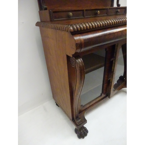 245 - A Cork Regency mahogany and rosewood cross banded side cabinet, the upper section having carved gall... 