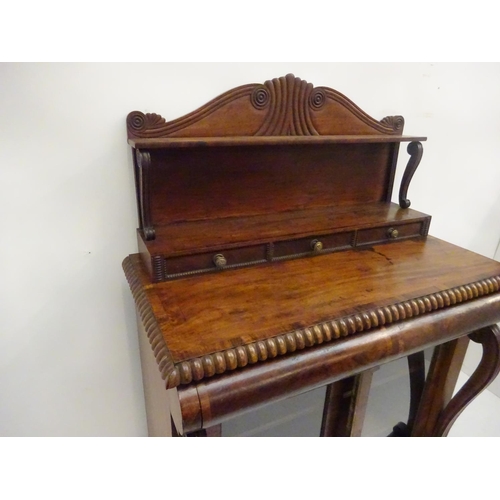 245 - A Cork Regency mahogany and rosewood cross banded side cabinet, the upper section having carved gall... 