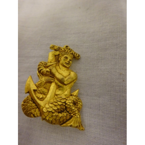 264 - Arthus Bertrand - a small 18ct brooch in the shape of a smiling merman with anchor entitled 