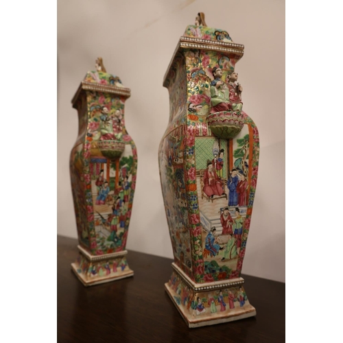 296 - A fine pair of Chinese Famille Rose Canton Export Vases with lids of square form, richly decorated i... 