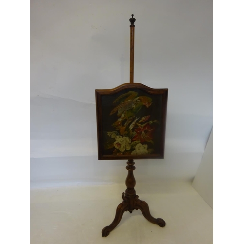 33 - Victorian mahogany pole screen raised on tripod base.