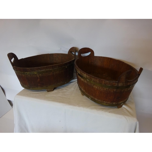 35 - A pair of antique oak and brass bound oval shaped vats. W. 50cm, D. 35cm, H. 20cm.  (one handle miss... 