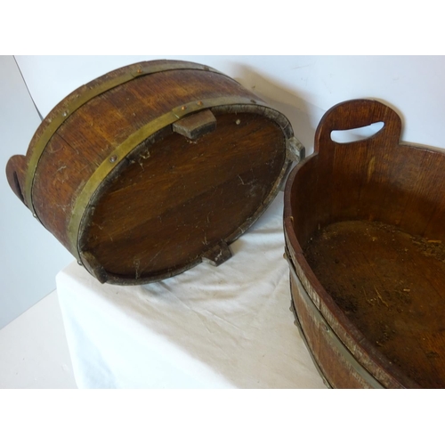 35 - A pair of antique oak and brass bound oval shaped vats. W. 50cm, D. 35cm, H. 20cm.  (one handle miss... 