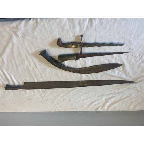 439 - A Gurka knife, two daggers and a long edged weapon in need of restoration.