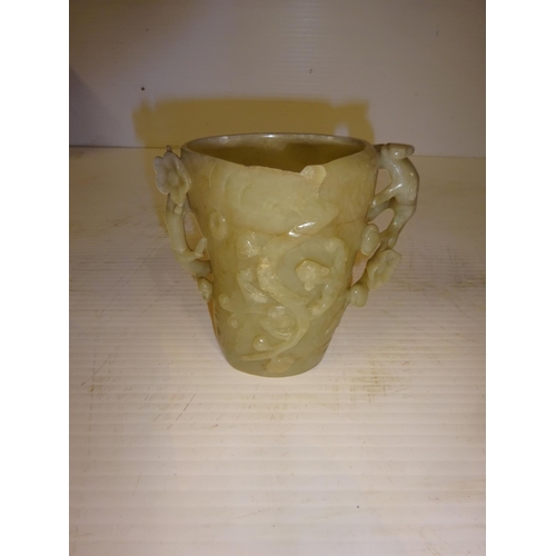 444 - An antique jade libation cup, carved around the exterior with bats amongst branches. (chip on top ri... 