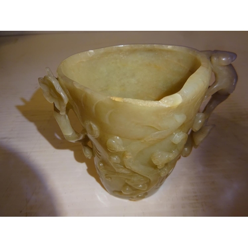 444 - An antique jade libation cup, carved around the exterior with bats amongst branches. (chip on top ri... 