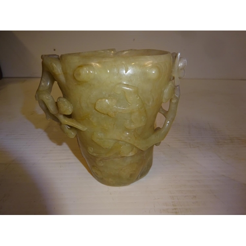 444 - An antique jade libation cup, carved around the exterior with bats amongst branches. (chip on top ri... 