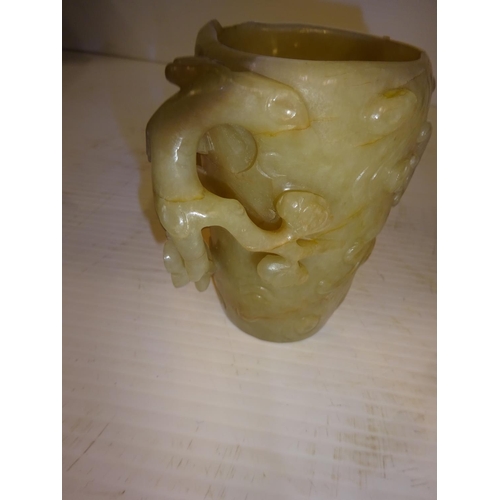 444 - An antique jade libation cup, carved around the exterior with bats amongst branches. (chip on top ri... 