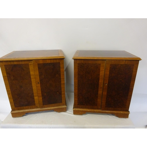 46 - A pair of low walnut two door side cabinets on castors. D. 38cm, W. 53cm, H. 60cm.