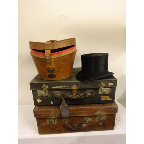 5 - Three suitcases and a top hat in case, the leather suitcase by Robert Day & Son, Cork, the top hat b... 