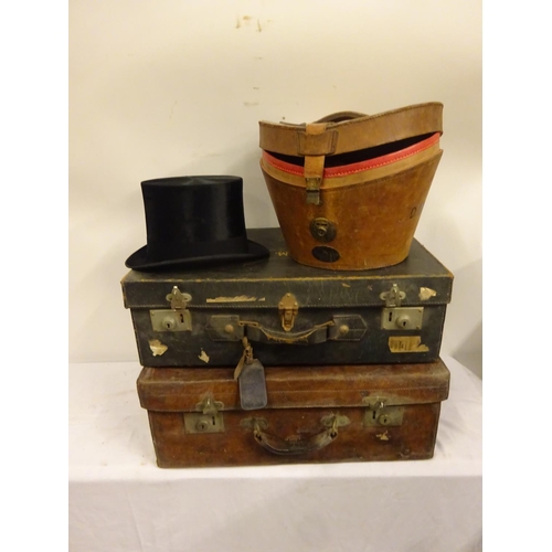 5 - Three suitcases and a top hat in case, the leather suitcase by Robert Day & Son, Cork, the top hat b... 