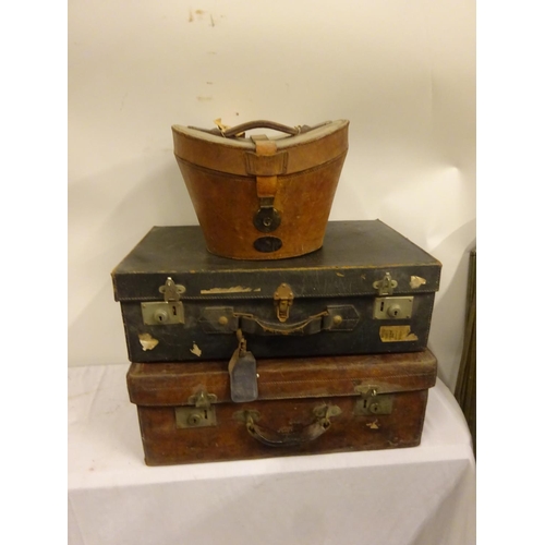 5 - Three suitcases and a top hat in case, the leather suitcase by Robert Day & Son, Cork, the top hat b... 