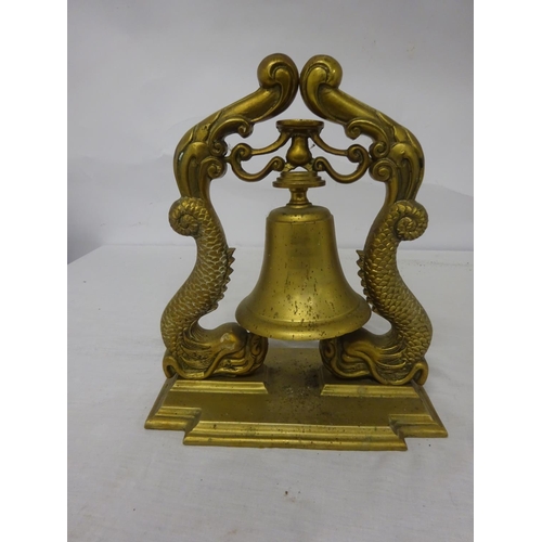 74 - Heavy brass bell on ornate supports and rectangular shaped base. Overall height 32cm. Base - 28cm x ... 