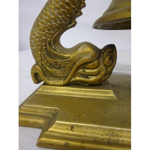 74 - Heavy brass bell on ornate supports and rectangular shaped base. Overall height 32cm. Base - 28cm x ... 