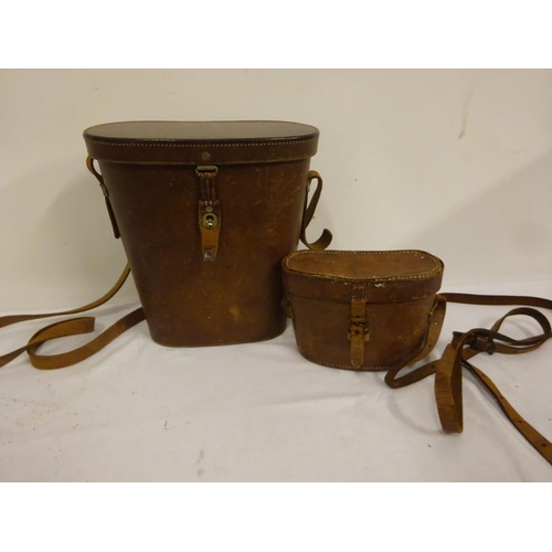 83 - Two pairs of binoculars in leather cases.