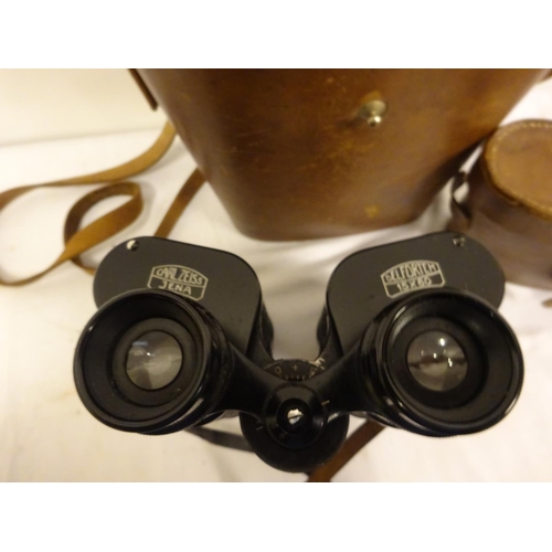 83 - Two pairs of binoculars in leather cases.