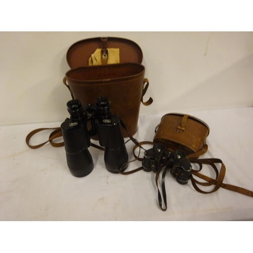 83 - Two pairs of binoculars in leather cases.