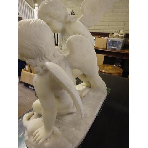 94 - A large old marble figure of two cherubs with bird on oval shaped base. W. 54cm, H. 50cm approx.