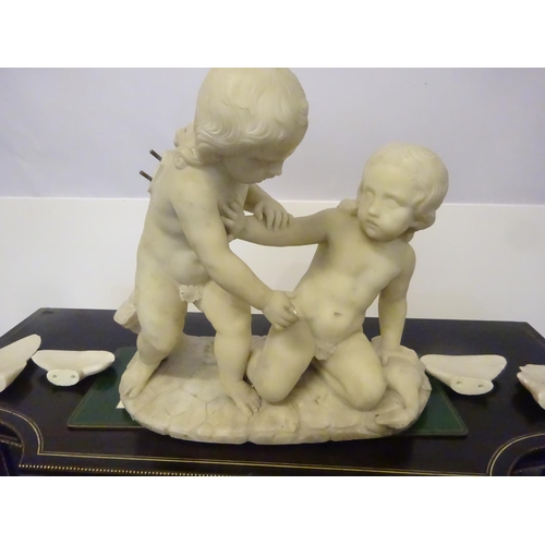 94 - A large old marble figure of two cherubs with bird on oval shaped base. W. 54cm, H. 50cm approx.