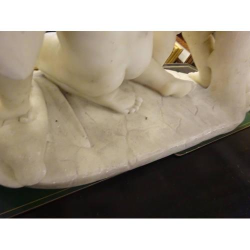 94 - A large old marble figure of two cherubs with bird on oval shaped base. W. 54cm, H. 50cm approx.