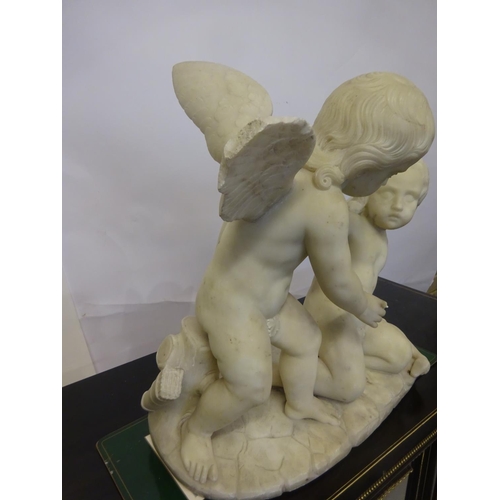 94 - A large old marble figure of two cherubs with bird on oval shaped base. W. 54cm, H. 50cm approx.