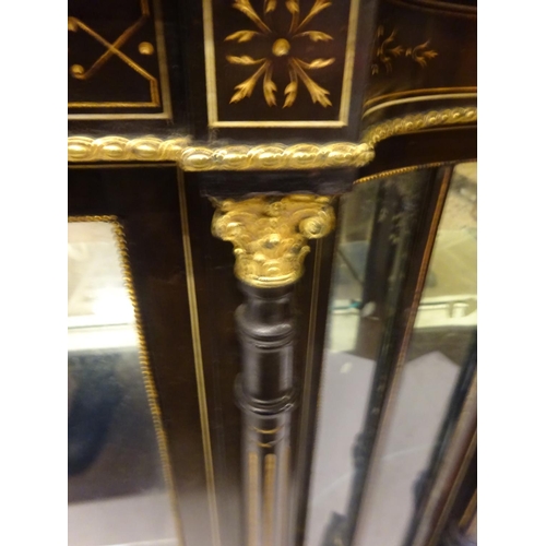 95 - A good ebonized drawing room cabinet having shaped top, the freize with copper plaque over inlaid an... 