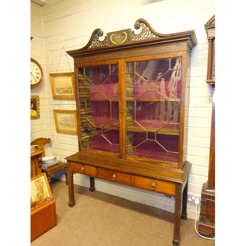 497 - A fine antique mahogany bookcase, the upper section having decorative swan neck cornice over two sec... 