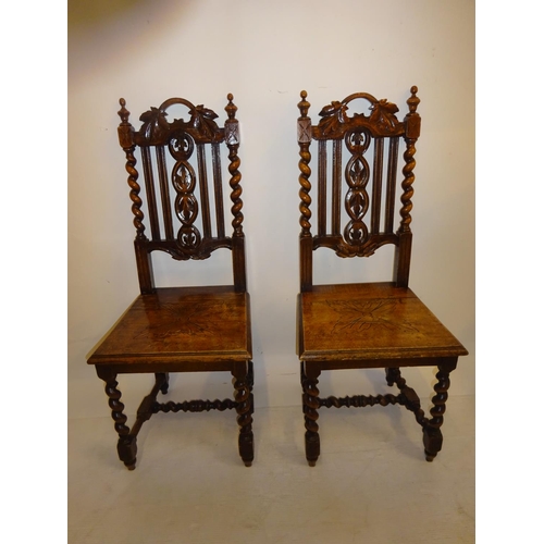 21 - Pair of antique carved oak hall chairs.