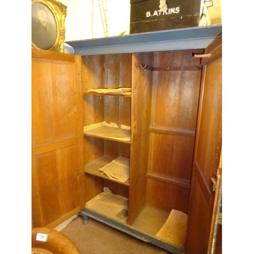 30 - Old painted pine two door press with shelved interior. W. 135cm, D. 55cm, H. 190cm approx.