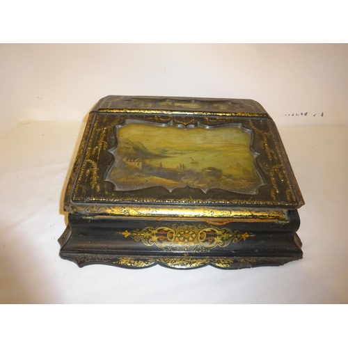 377 - A Victorian paper mache writing slope having landscape scenes and gilt decoration.