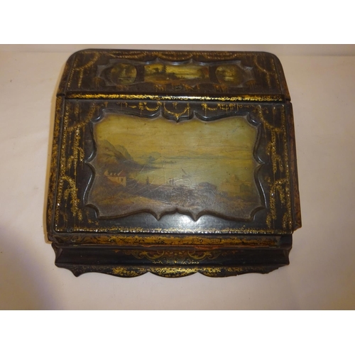 377 - A Victorian paper mache writing slope having landscape scenes and gilt decoration.