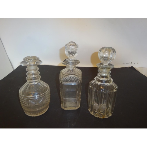 387 - Three antique cut glass decanters and stoppers.