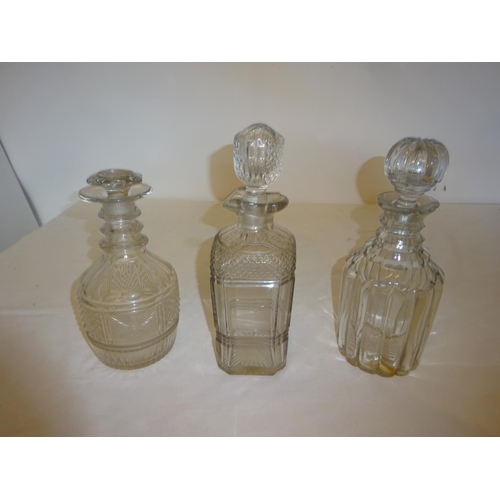 387 - Three antique cut glass decanters and stoppers.