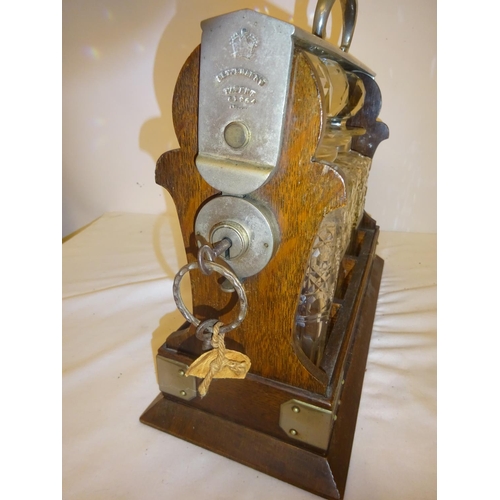 401 - Victorian tantalus having 3 cut glass bottles and key.