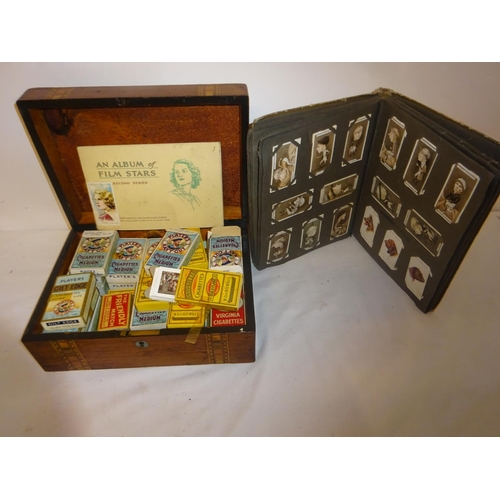 402 - A collection of old cigarette boxes with cards, an album of cigarette cards and another box of cigar... 