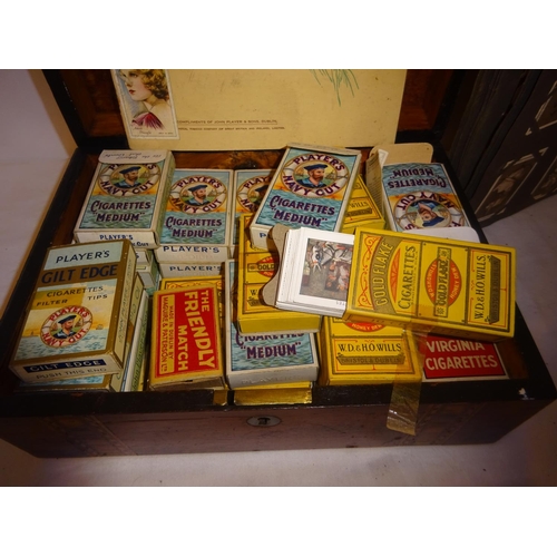 402 - A collection of old cigarette boxes with cards, an album of cigarette cards and another box of cigar... 