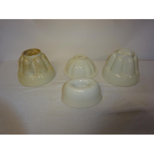 11 - Four old jelly moulds.