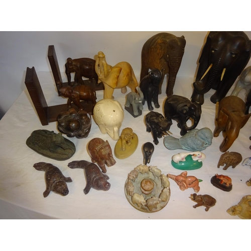 126 - A lot of carved wood elephants and china, marble and metal figures of animals.