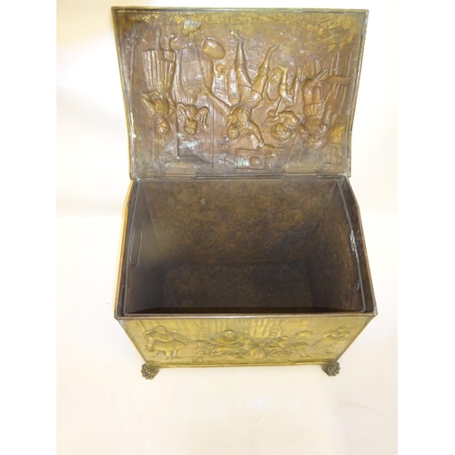 141 - Good old brass coal box with raised figure decoration, complete with liner. W. 57cm.