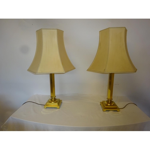 19 - A pair of tall brass side lamps and shades on square bases. Lamp height 50cm.