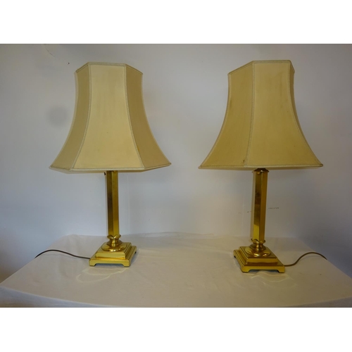 19 - A pair of tall brass side lamps and shades on square bases. Lamp height 50cm.