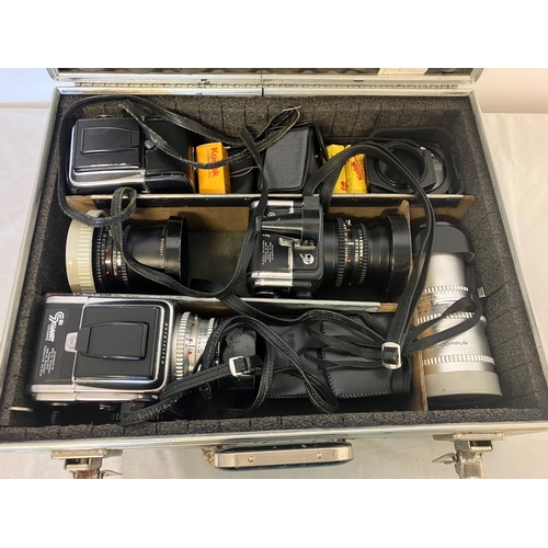 204 - An Industrial Photographer's cased collection of cameras, lenses, etc. See photo.