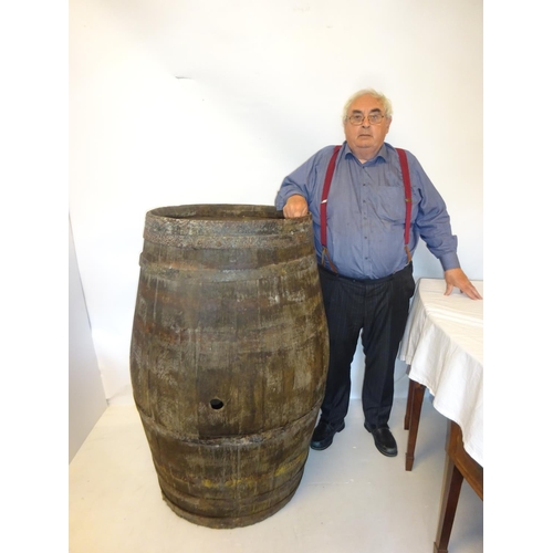 221 - A large old oak sherry barrel. H. 130cm. Diameter at top 70cm.