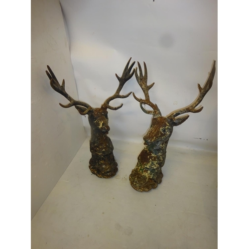 223 - A pair of heavy cast iron gate pillar deer heads. Overall height 83cm.