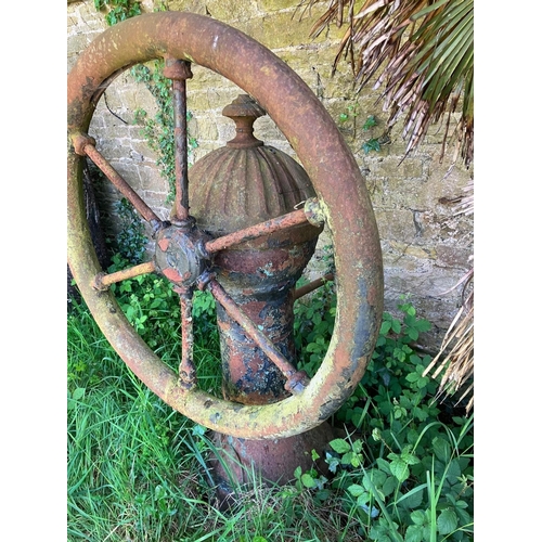 228 - A rare antique cast iron village pump. Diameter of wheel 95cm, overall height 140cm.