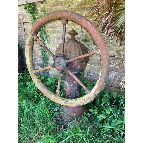 228 - A rare antique cast iron village pump. Diameter of wheel 95cm, overall height 140cm.