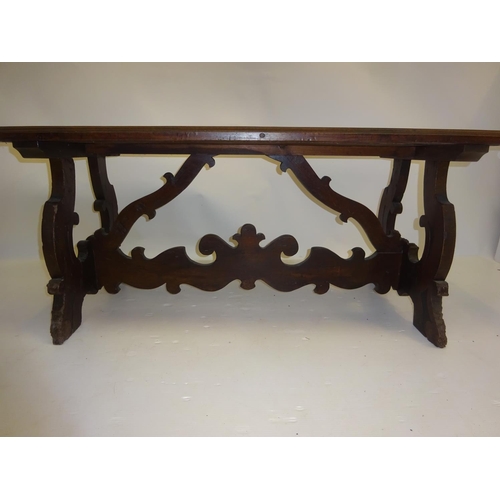 253 - Antique oak pugin style occasional table raised on end supports and cross stretcher. W. 130cm, D. 58... 